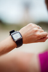 Woman checking her fitness watch while training