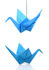 A blue origami bird isolated white