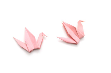 Two pink origami cranes isolated on white background.