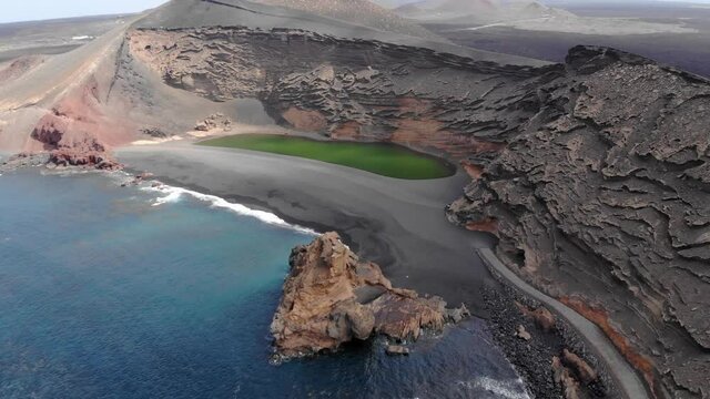 Volcanic crater with lake and ocean near El Golfo, Lanzarote, Spain. Aerial view