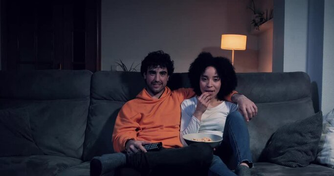 Couple on the sofa at home watching a movie or series on tv