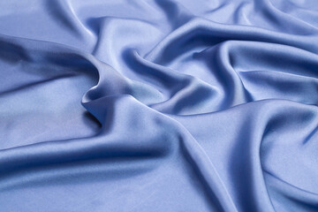 Blue silk or satin luxury fabric texture. Top view.