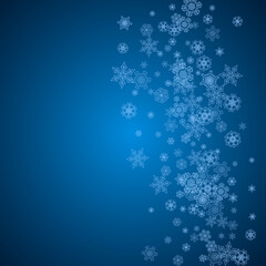 Fototapeta premium New Year snowflakes on blue background with sparkles. Winter theme. Christmas and New Year snowflakes falling. For season sales, special offer, banners, cards, party invites, flyer. White frosty snow