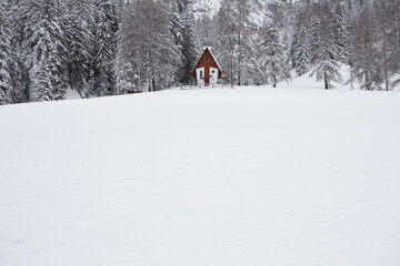 Alpine church in the snow in Dolomiti moutains