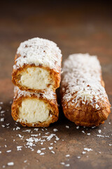 Coconut eclairs. Traditional French dessert. Eclair cutaway. Selective focus