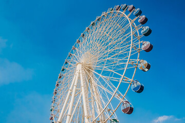 Ferris wheel against the blue sky