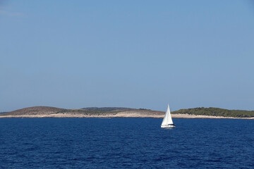 Sailing boat near island in Croatia. Beautiful Mediterranean landscape.