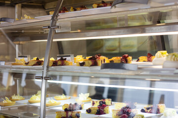 Cakes on plates under glass 