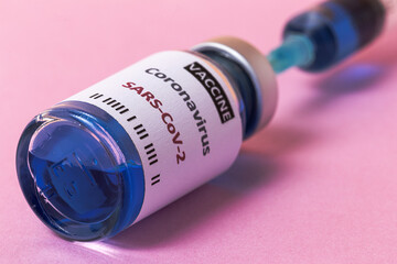 Transparent glass vials with test COVID-19 vaccine, with syringes