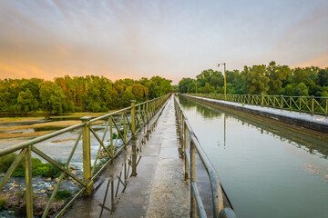 Sunset after a rainy day on the Guetin Canal bridge, a canal spanning over the Allier river in Cuffy, a small town of the Berry region (France)