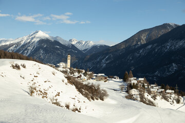 The sunny village of Brienz/Brinzauls in the canton of Graub&uuml;nden in Switzerland. The village is built in a landslide area on unstable ground and the buildings show signs of cracking and deformation. 