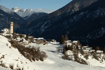 The sunny village of Brienz/Brinzauls in the canton of Graub&uuml;nden in Switzerland. The village is built in a landslide area on unstable ground and the buildings show signs of cracking and deformation. 
