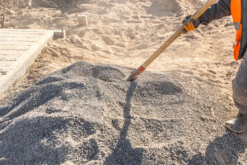 Loading construction mix with a shovel at a construction site
