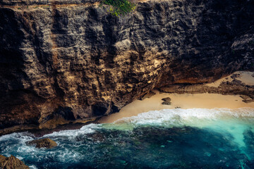Aerial view on beach with waves and the cliff. This is the cliff of Broken Beach, Nusa Penida Island, Klingung regency, Bali, Indonesia. 