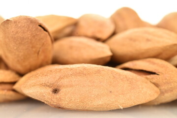 unpeeled almonds Dried unpeeled almonds, close-up, isolated on white.