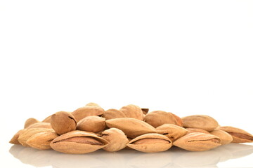 Dried unpeeled almonds, close-up, isolated on white.