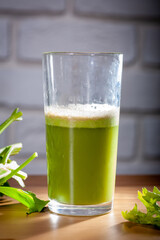 Healthy Celery diet for the treatment of incurable mysterious diseases. Fresh celery juice squeezed out on a juicer.drink, vegetable juice, studio shot
