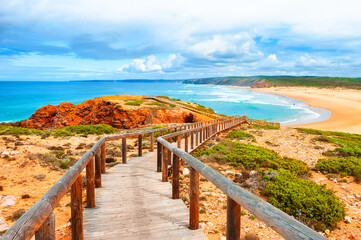 Beautiful shore of Atlantic ocean and stairs to the beach. Algarve, Portugal. Beautiful summer landscape