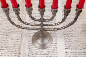 Old scrolls of the Bible and Menorah lie on a black background. Religion. Bible. Bible books. Christianity. God. Hebrew. Old chronicles. Israel. Jerusalem. Menorah. Seven candles.