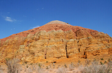 Aktau Mountains on sunrise. Beautiful landscape of colorful mountains in desert. Nature reserve Altyn Emel. Kazakhstan. Panorama with copy space