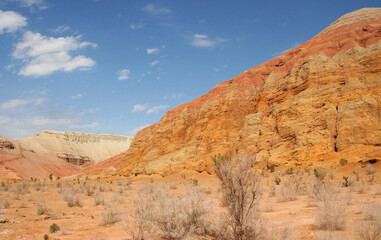 Aktau Mountains on sunrise. Beautiful landscape of colorful mountains in desert. Nature reserve Altyn Emel. Kazakhstan