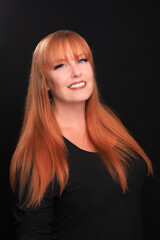 Fototapeta premium Red Haired Head Shot of Woman on Black Background