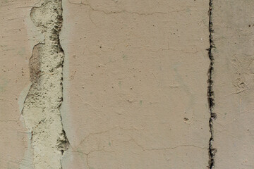 Grey texture of old broken asphalt road or wall big abrasions cracks holes on the surface pebbles cement in Sofia, Bulgaria, Eastern Europe