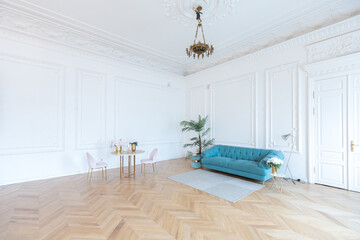 chic spacious light room in an old mansion in the classical style of the 19th century with a high ceiling decorated with stucco on white walls