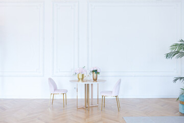 chic spacious light room in an old mansion in the classical style of the 19th century with a high ceiling decorated with stucco on white walls