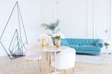chic spacious light room in an old mansion in the classical style of the 19th century with a high ceiling decorated with stucco on white walls