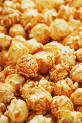 Popcorn in caramel glaze close-up as a background.