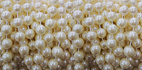 texture of natural iridescent ivory white pearls set in strings for necklaces or any jewel