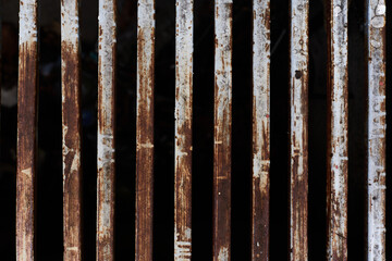 Rusty metal rods isolated on black background poverty prison age retro concept in urban scene
