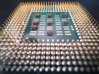 Vintage central processing unit's surface with golden contact pins. Shallow depth of field  macro...
