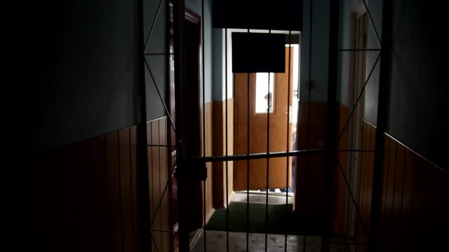 alk through the prison corridor. Prisoner enter into the cell, doors are closing.