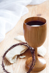 Chalice of wine, passover bread, thorns as Jesus Last Supper and Passion of Christ concept