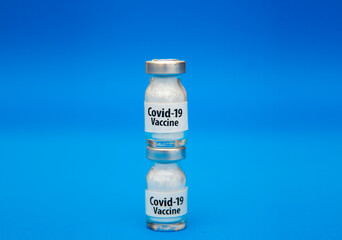 Coronavirus vaccine concept isolated on blue background.  Covid-19, 2019-nCov pandemic.