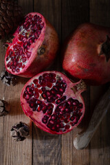 Pieces of fresh pomegranate on a dark wooden background. Food background. 