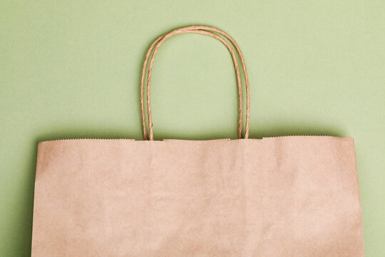 Empty brown paper shopping bag with Handles.