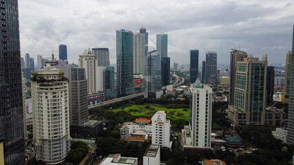 Aerial view of highway intersection and buildings in the city of Jakarta and noise cloud with Jakarta cityscape. JAKARTA - Indonesia. January 30, 2021