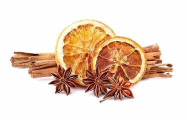 Dry orange with  cinnamon  and anise on white background closeup. Citrus with spices.