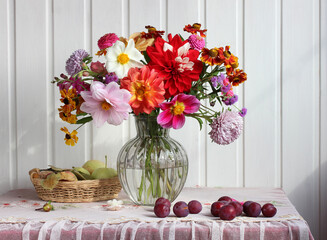 autumn still life with a bouquet and fruit. garden flowers.