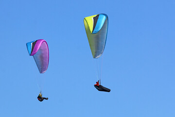 Paraglider flying wing in a blue sky	