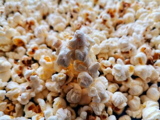 Popcorn.  Popcorn on the plate.  Eating popcorn while watching the cinema.