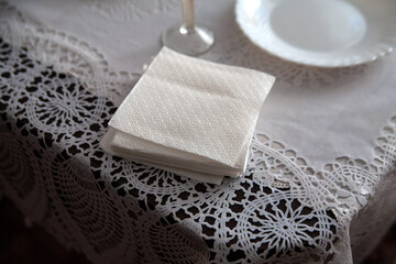 Paper napkins are on the festive table. On a white blanket.