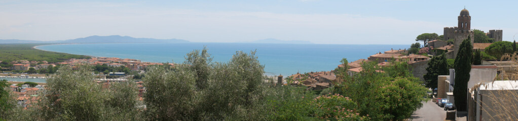 Panorama of the fortified medieval village of Castiglione della Pescaia and of its coast lapped by the Tyrrhenian Sea.