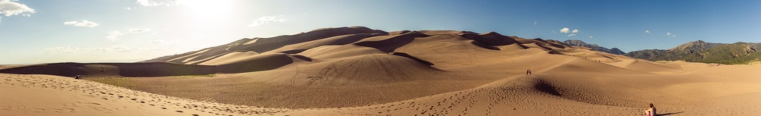 Fototapeta na wymiar Panorama shot of sandy dunes in great sand dunes national park at sunny day in america