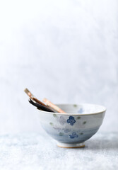 Obraz na płótnie Canvas Traditional ceramic bowl on bright background. Copy space. 