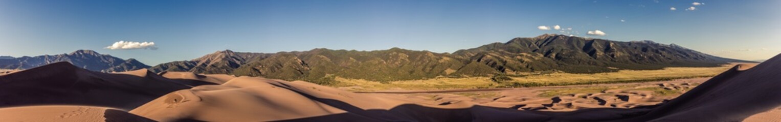 Panorama view of mountains and sandy dunes at sunny day in great sand dunes national park in america
