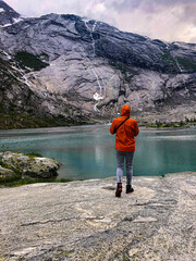 Tourist going to the lake down the mountain